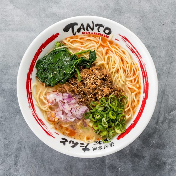 Tanto Gyoza and Ramen Bar's ramen bowl with noodles, ground meat, spinach, red onions, and green onions.